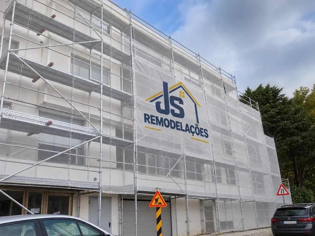 Fachada protegida com andaimes e tela JS Remodelações.